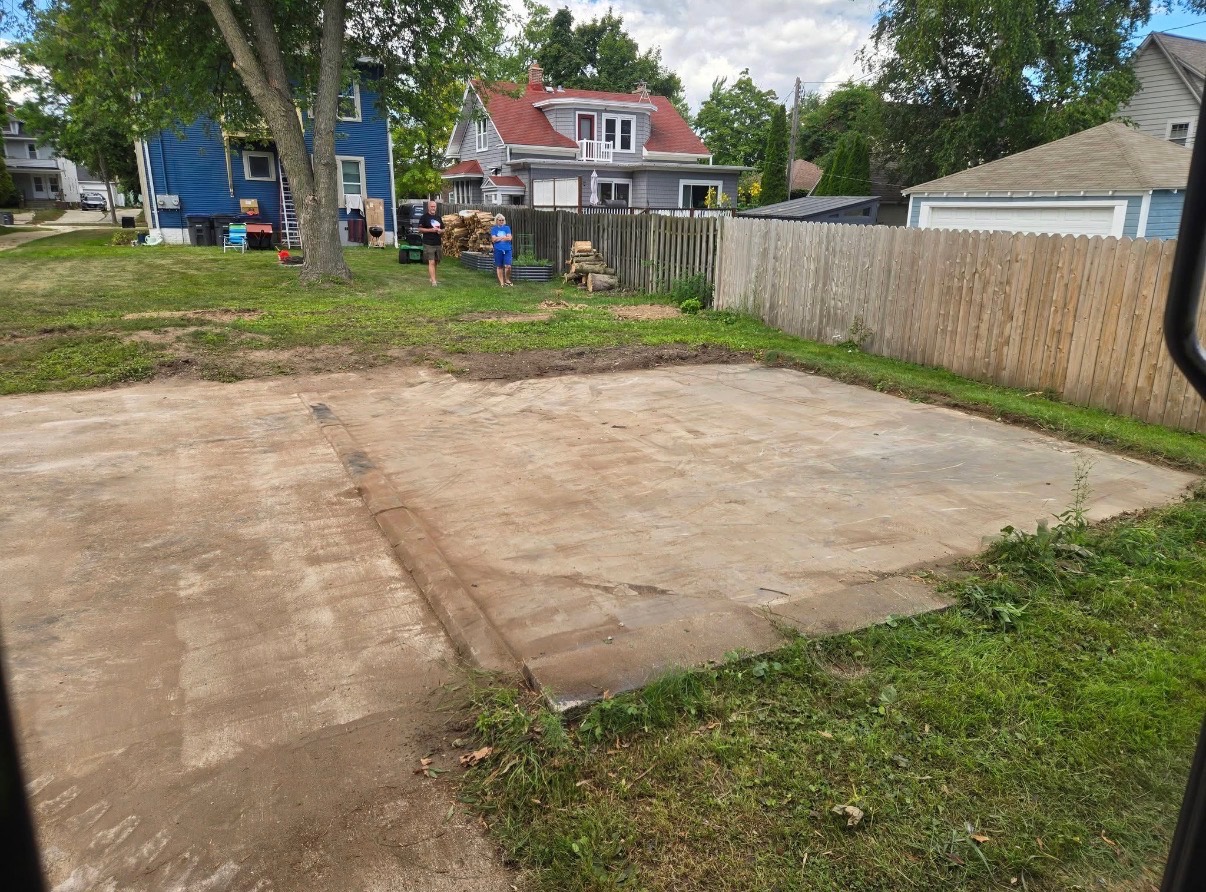 Cleared concrete slab remaining after garage demolition and debris removal